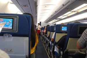 Airline attendant informs the  passengers to place their safety belts before take off from  Ninoy Aquino International Airport ( NAIA ) bound to Hong Kong , August 29 , 2009.