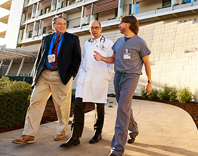 Drs. Concepcion, Cornfield and Sidell walking in front of the new Lucile Packard Children's Hospital Stanford in Palo Alto