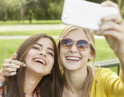 Two teens taking selfies