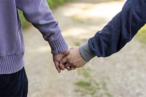 Two people holding hands