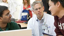 Photo of a doctor speaking with two medical students