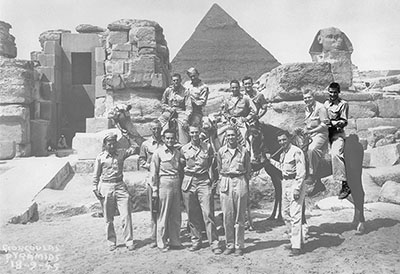 Sergeant William H. Rehnquist seated on a horse (far right) posing with others in front of the Sphynx and Pyramids outside Cairo, Egypt, on September 18, 1945.